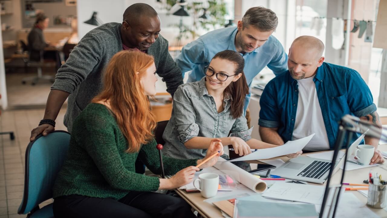Group of people working together on a project in a startup company office